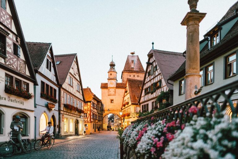 A cobblestone street in a german town at dusk.